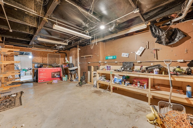 733 N Main St, Evart, MI 49631 - unfinished below grade area featuring a workshop area