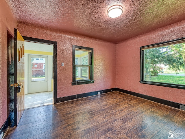 3375 Clinton Way, Jackson, MI 49201 - unfurnished room featuring a textured wall, dark wood-style floors, and a textured ceiling