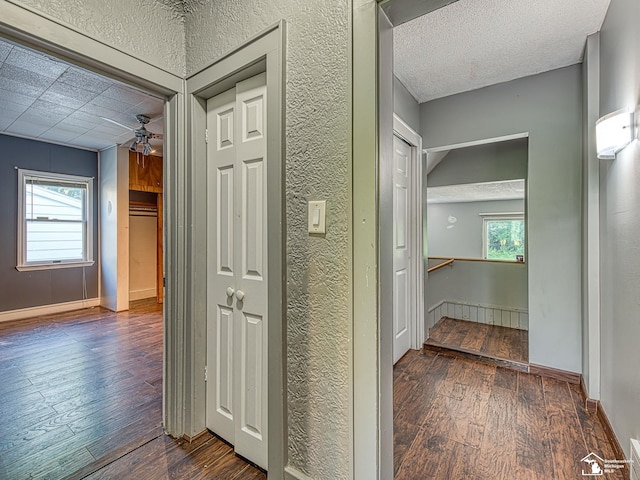 3375 Clinton Way, Jackson, MI 49201 - corridor with hardwood / wood-style flooring, an upstairs landing, a textured wall, and a textured ceiling