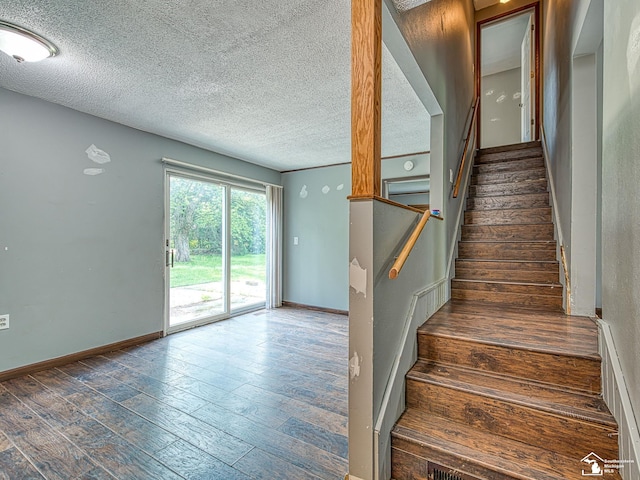 3375 Clinton Way, Jackson, MI 49201 - stairway with a textured ceiling and wood finished floors