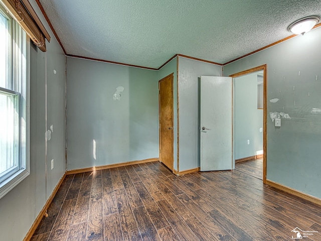 3375 Clinton Way, Jackson, MI 49201 - unfurnished bedroom featuring crown molding, a textured ceiling, and wood finished floors