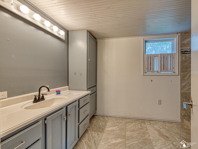 3375 Clinton Way, Jackson, MI 49201 - bathroom with marble look tiles, vanity, and wood ceiling