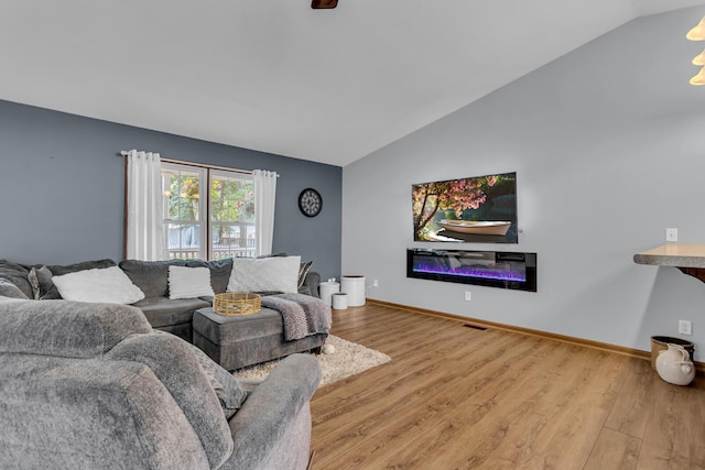2151 Glenwood Ct, Brooklyn, MI 49230 - living room featuring lofted ceiling, wood finished floors, and a glass covered fireplace