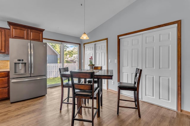 2151 Glenwood Ct, Brooklyn, MI 49230 - dining space featuring vaulted ceiling and light wood-type flooring