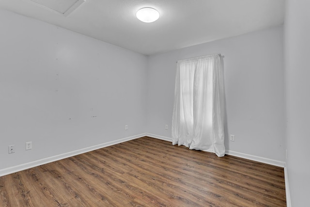 2151 Glenwood Ct, Brooklyn, MI 49230 - unfurnished room with baseboards and dark wood-style flooring