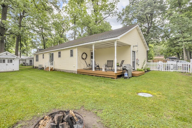 2151 Glenwood Ct, Brooklyn, MI 49230 - rear view of property featuring an outdoor fire pit, entry steps, a deck, and a shed
