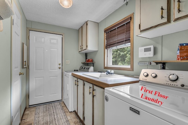 11277 N Dr, Brooklyn, MI 49230 - washroom with cabinet space, washer and clothes dryer, a textured ceiling, and stone finish flooring