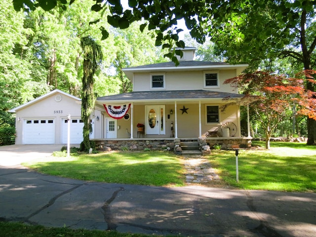 5933 Mccain Rd, Jackson, MI 49201 - view of front of property featuring a garage, a front lawn, covered porch, and concrete driveway