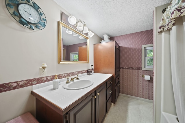 5933 Mccain Rd, Jackson, MI 49201 - full bath with wallpapered walls, vanity, a textured ceiling, and tile patterned floors