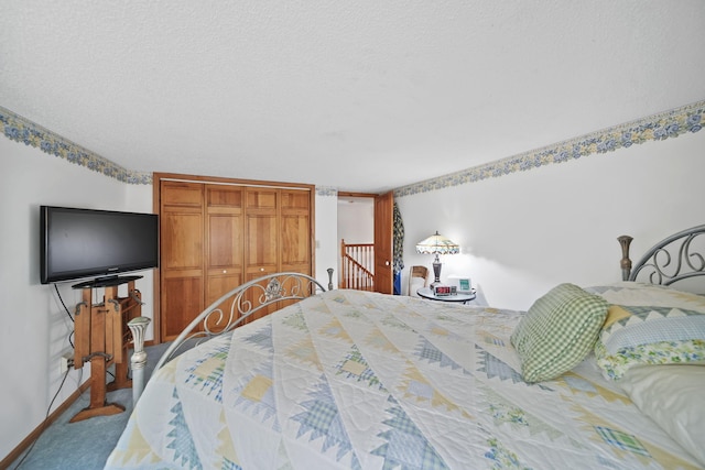 5933 Mccain Rd, Jackson, MI 49201 - carpeted bedroom featuring a closet and a textured ceiling