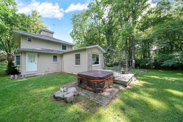 5933 Mccain Rd, Jackson, MI 49201 - back of property featuring a hot tub and a lawn