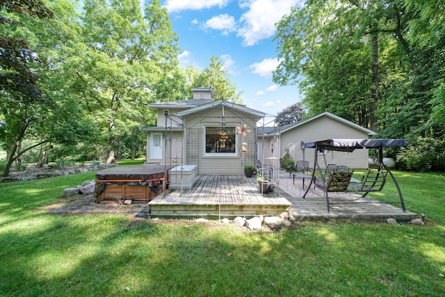 5933 Mccain Rd, Jackson, MI 49201 - back of property with a hot tub, a chimney, a wooden deck, and a lawn