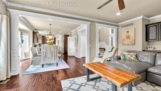 19492 Springbrook Dr, Macomb, MI 48044 - living room featuring ceiling fan, dark wood-style floors, crown molding, recessed lighting, and a chandelier