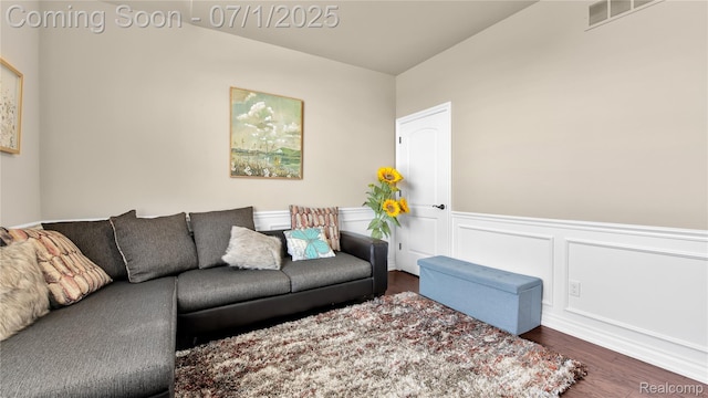 19492 Springbrook Dr, Macomb, MI 48044 - living area with dark wood-style floors and wainscoting