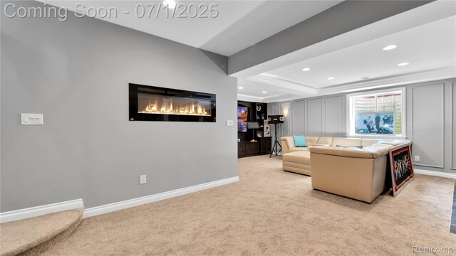 19492 Springbrook Dr, Macomb, MI 48044 - living area with light carpet, recessed lighting, and a glass covered fireplace