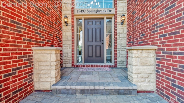 19492 Springbrook Dr, Macomb, MI 48044 - doorway to property with brick siding