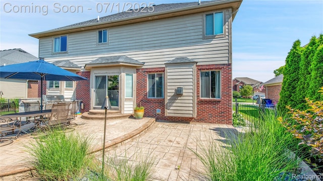19492 Springbrook Dr, Macomb, MI 48044 - back of property featuring brick siding and a patio area