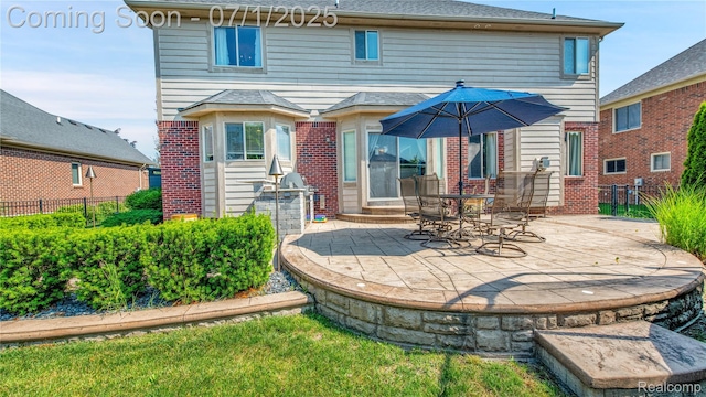 19492 Springbrook Dr, Macomb, MI 48044 - back of house with brick siding and a patio