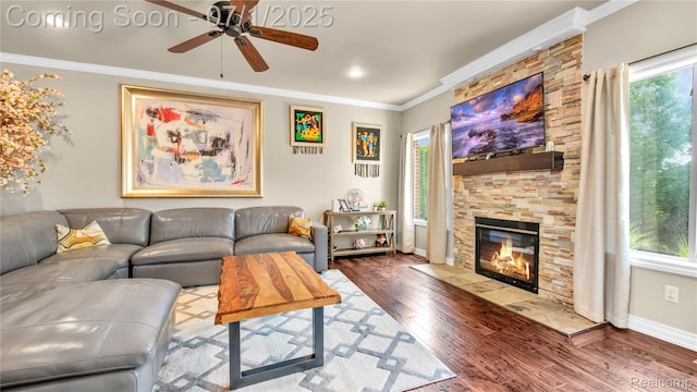 19492 Springbrook Dr, Macomb, MI 48044 - living area featuring ceiling fan, wood finished floors, a stone fireplace, and crown molding