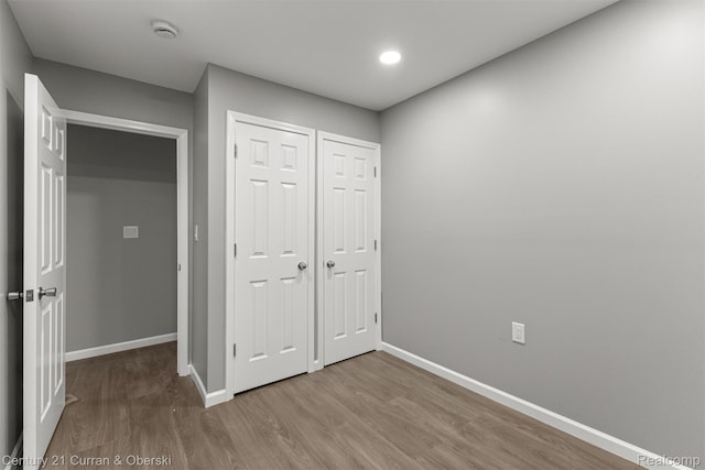 1587 Reo Ave, Lincoln Park, MI 48146 - unfurnished bedroom with wood finished floors and recessed lighting