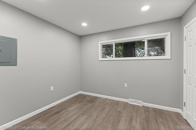 1587 Reo Ave, Lincoln Park, MI 48146 - unfurnished room featuring electric panel, wood finished floors, and recessed lighting