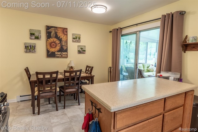9595 Pearl Beach Blvd, Clay, MI 48001 - kitchen featuring light countertops, brown cabinetry, and a baseboard heating unit
