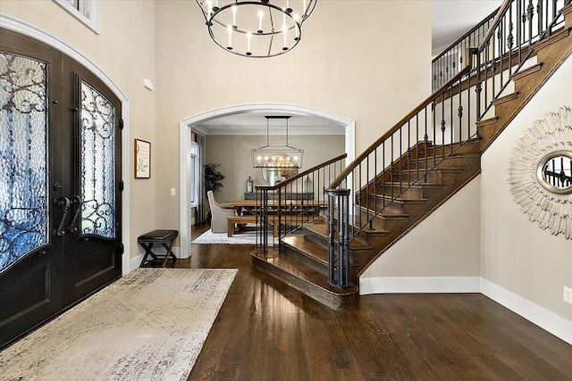 1988 Christenbury Ct, Rochester, MI 48306 - foyer with a chandelier, a high ceiling, arched walkways, stairs, and french doors