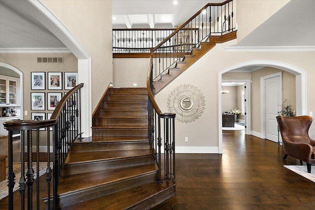1988 Christenbury Ct, Rochester, MI 48306 - staircase with arched walkways, a towering ceiling, wood finished floors, and crown molding