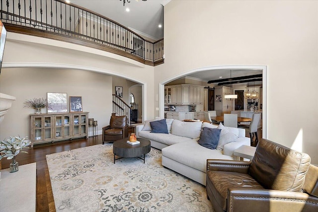 1988 Christenbury Ct, Rochester, MI 48306 - living room featuring arched walkways, a high ceiling, wood finished floors, a chandelier, and stairs