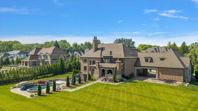 1988 Christenbury Ct, Rochester, MI 48306 - back of property featuring a chimney, stone siding, and a patio