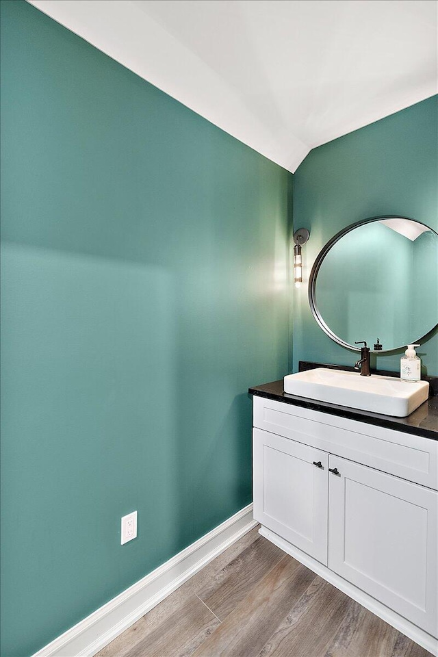 1988 Christenbury Ct, Rochester, MI 48306 - bathroom featuring wood finished floors, vanity, and lofted ceiling