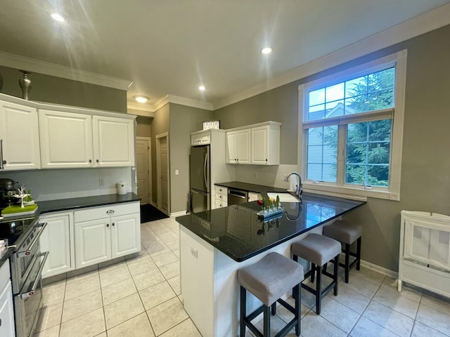 3643 Waterway Ct, Grass Lake, MI 49240 - kitchen with stainless steel appliances, light tile patterned floors, white cabinetry, a peninsula, and crown molding