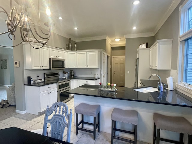 3643 Waterway Ct, Grass Lake, MI 49240 - kitchen featuring appliances with stainless steel finishes, a peninsula, white cabinetry, crown molding, and recessed lighting