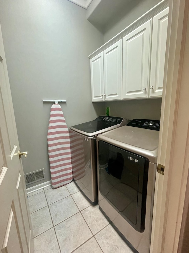 3643 Waterway Ct, Grass Lake, MI 49240 - laundry room with separate washer and dryer, cabinet space, and light tile patterned floors