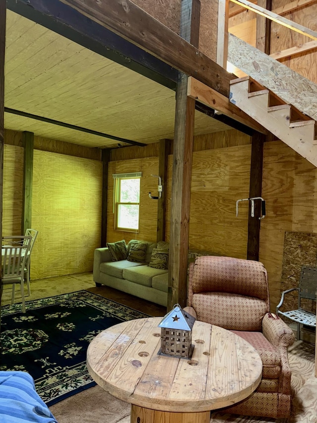 23266 Hayes Rd, Big Rapids, MI 49307 - living room with wooden walls, stairs, and carpet