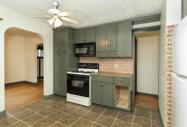 7125 Edwards Rd, Michigan, MI 48111 - kitchen featuring black microwave, range with gas stovetop, green cabinets, a ceiling fan, and arched walkways