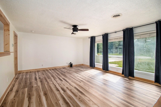 1722 Benson, Fountain, MI 49410 - unfurnished room with a textured ceiling, a ceiling fan, and light wood-style flooring