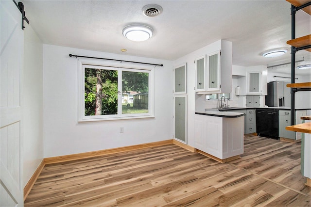 1722 Benson, Fountain, MI 49410 - kitchen featuring dishwasher, light wood finished floors, white cabinetry, and dark countertops