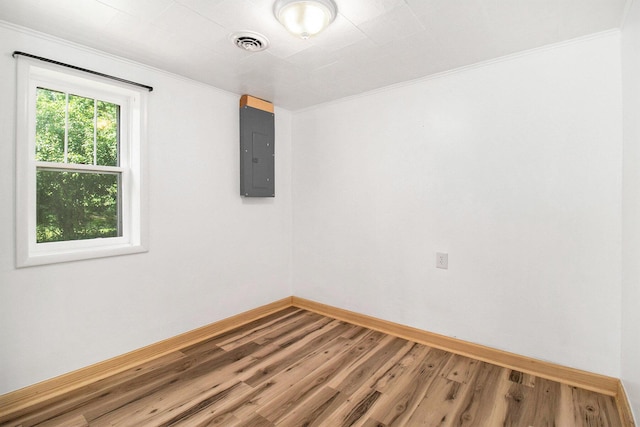 1722 Benson, Fountain, MI 49410 - spare room featuring electric panel, wood finished floors, and ornamental molding
