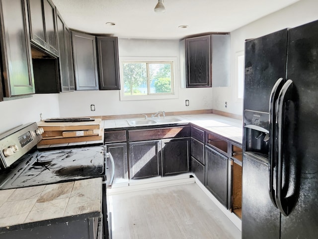 730 W Mohawk Trl, White Cloud, MI 49349 - kitchen featuring black fridge with ice dispenser, stainless steel range, light countertops, and recessed lighting