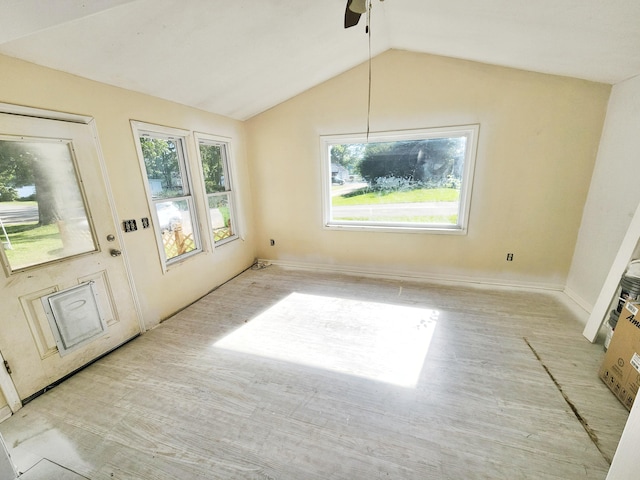 730 W Mohawk Trl, White Cloud, MI 49349 - unfurnished dining area featuring healthy amount of natural light, lofted ceiling, ceiling fan, and light wood-style flooring