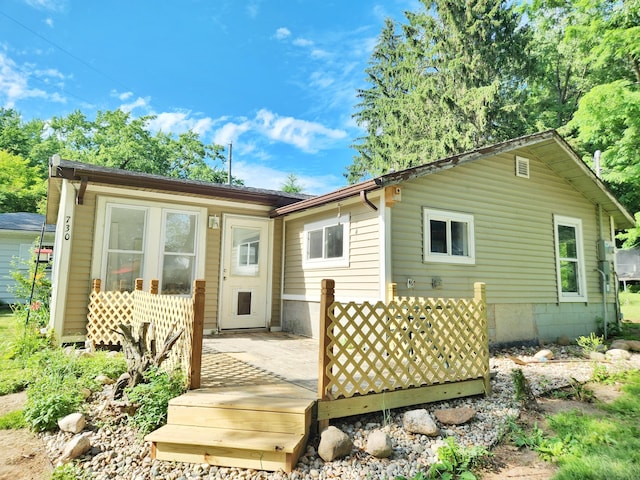 730 W Mohawk Trl, White Cloud, MI 49349 - back of property with a wooden deck