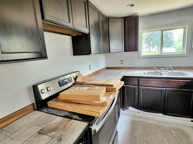730 W Mohawk Trl, White Cloud, MI 49349 - kitchen with stainless steel range with electric stovetop, light wood finished floors, light countertops, and dark brown cabinetry