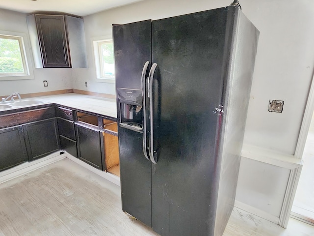730 W Mohawk Trl, White Cloud, MI 49349 - kitchen featuring black fridge, healthy amount of natural light, light countertops, and dark brown cabinetry