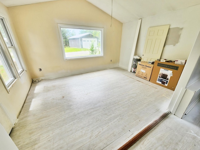 730 W Mohawk Trl, White Cloud, MI 49349 - unfurnished room featuring plenty of natural light, light wood finished floors, and vaulted ceiling