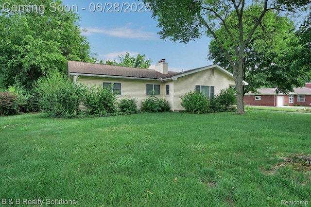 3423 Nichols Rd, Auburn Hills, MI 48326 - view of front of house with a chimney and a front lawn
