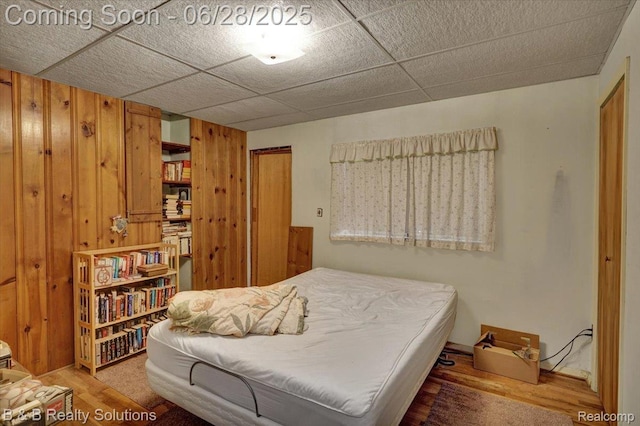 3423 Nichols Rd, Auburn Hills, MI 48326 - bedroom with wooden walls and wood finished floors