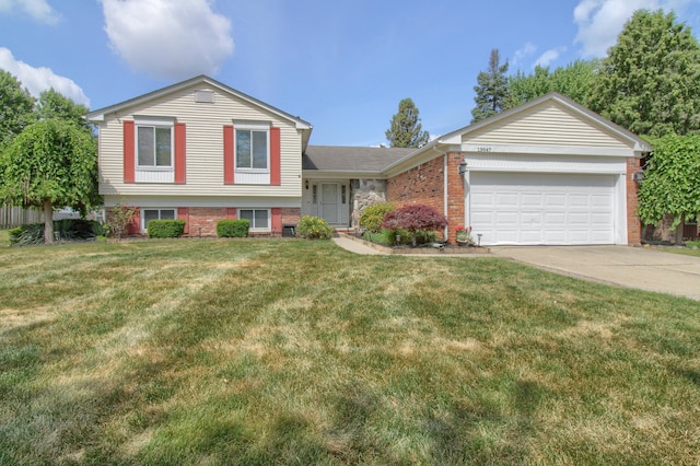 13947 Ashurst St, Livonia, MI 48154 - tri-level home with a garage, driveway, brick siding, and a front yard