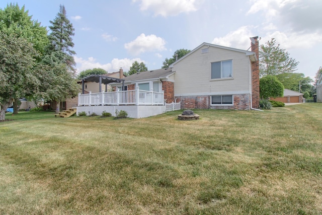 13947 Ashurst St, Livonia, MI 48154 - rear view of house featuring a pergola, a chimney, an outdoor fire pit, and a yard
