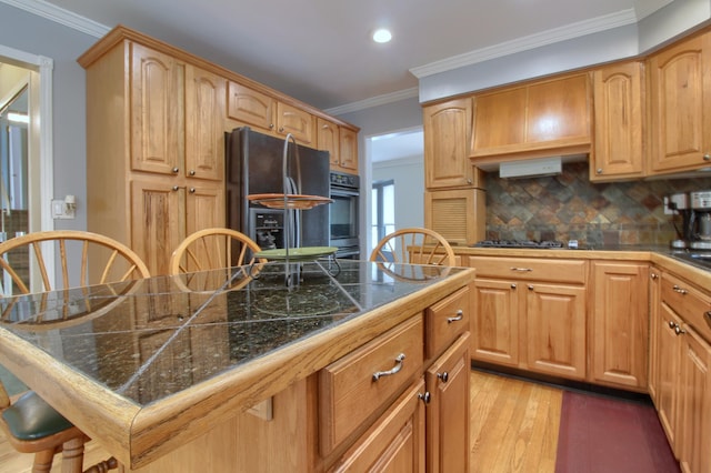 13947 Ashurst St, Livonia, MI 48154 - kitchen featuring black appliances, tasteful backsplash, light wood finished floors, a kitchen breakfast bar, and recessed lighting